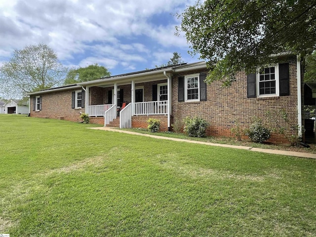 ranch-style house with covered porch, brick siding, and a front lawn