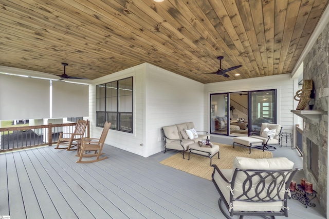 wooden terrace with ceiling fan and outdoor lounge area