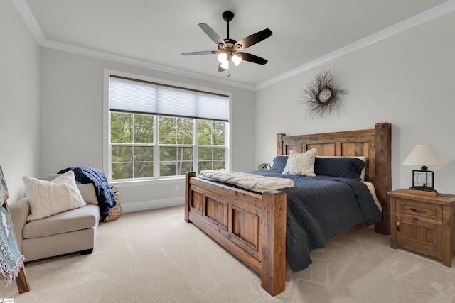 bedroom featuring baseboards, ornamental molding, ceiling fan, and light carpet