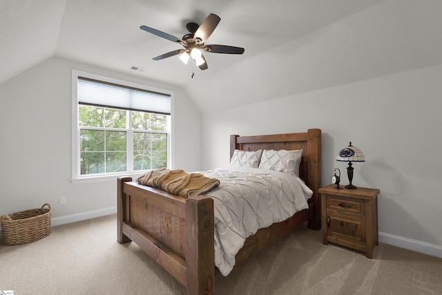 carpeted bedroom featuring baseboards, ceiling fan, vaulted ceiling, and visible vents