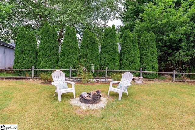 view of yard featuring fence and an outdoor fire pit
