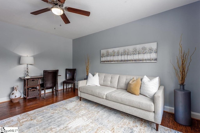 living room with baseboards, ceiling fan, and wood finished floors