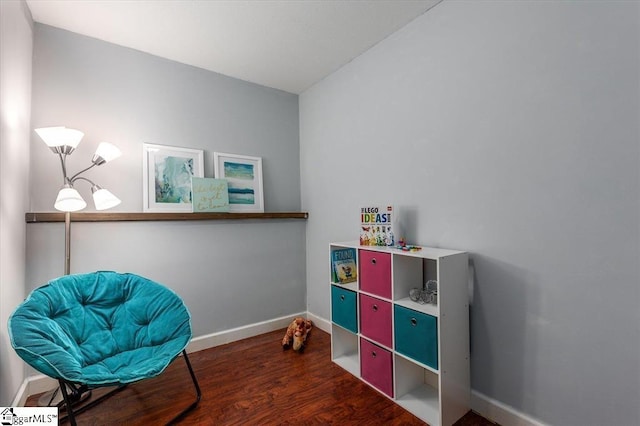 living area featuring baseboards and wood finished floors