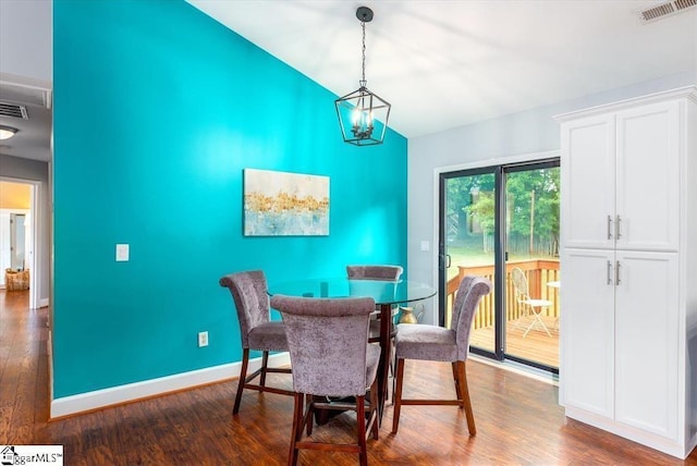 dining space featuring baseboards, dark wood-style floors, high vaulted ceiling, and visible vents