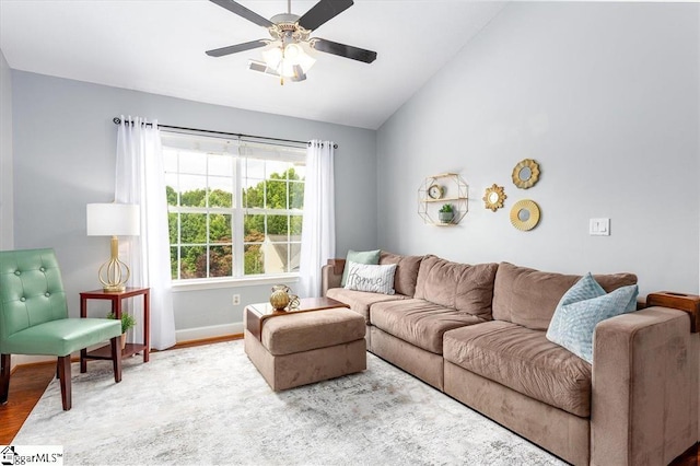 living area with visible vents, a ceiling fan, baseboards, wood finished floors, and vaulted ceiling