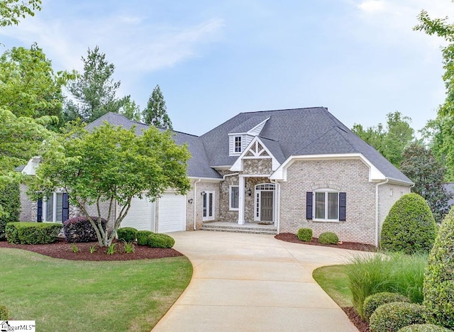 7 Broadstone Ct, Simpsonville, SC 29681 - view of front of property featuring driveway, a front yard, roof with shingles, brick siding, and an attached garage