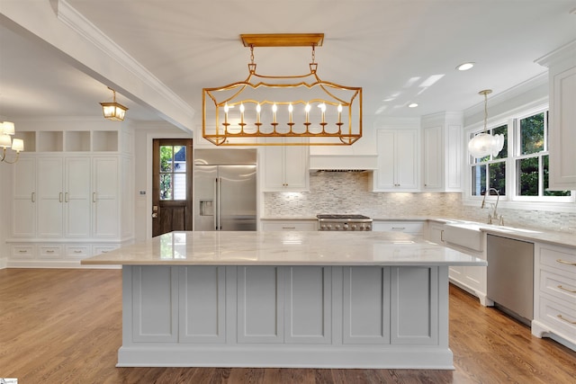 kitchen with white cabinetry, a kitchen island, a chandelier, and stainless steel appliances