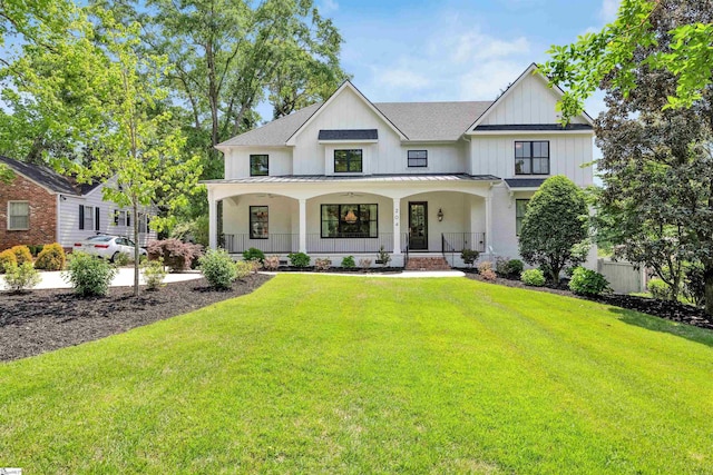 modern farmhouse style home featuring covered porch, a standing seam roof, metal roof, roof with shingles, and a front lawn