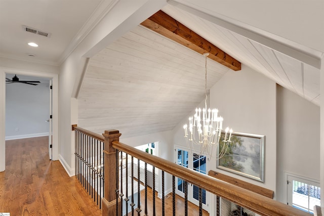 hallway featuring visible vents, an upstairs landing, wood finished floors, lofted ceiling with beams, and a notable chandelier