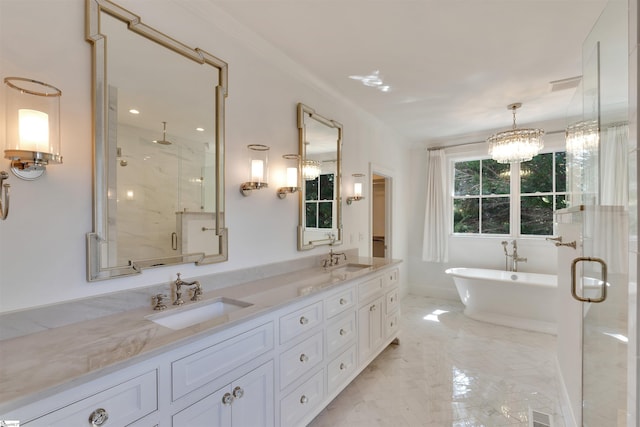 full bath with double vanity, a sink, a freestanding bath, and a stall shower