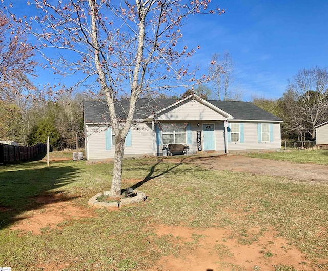 view of front of property with a front lawn and fence