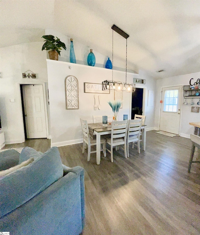 dining room featuring baseboards, visible vents, and wood finished floors