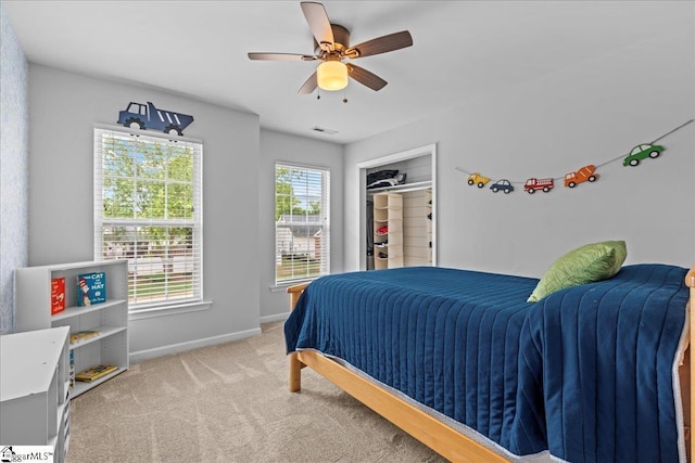 bedroom featuring carpet, a ceiling fan, baseboards, visible vents, and a closet