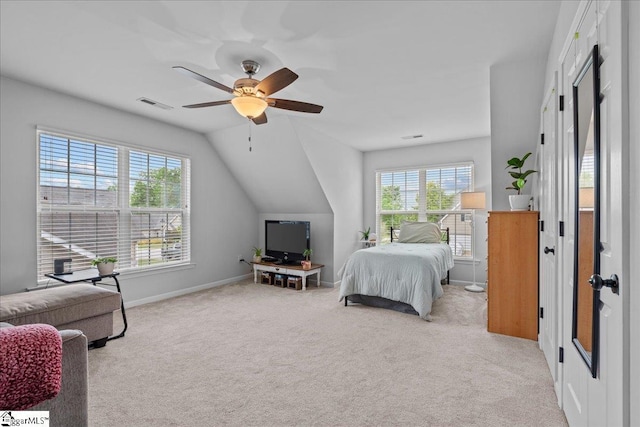 bedroom featuring visible vents, baseboards, ceiling fan, carpet flooring, and vaulted ceiling