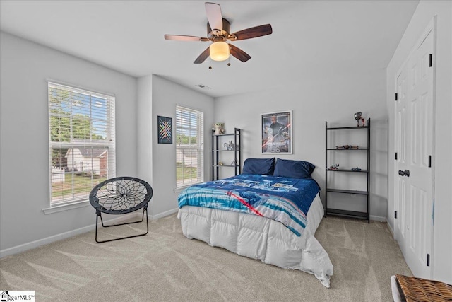 bedroom with carpet flooring, a ceiling fan, baseboards, and visible vents