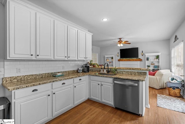 kitchen with white cabinets, ceiling fan, a sink, dishwasher, and open floor plan