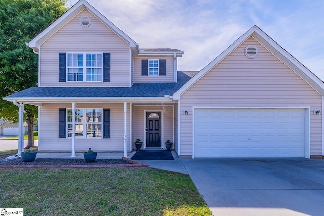 traditional-style home featuring roof with shingles, a garage, a front yard, covered porch, and driveway