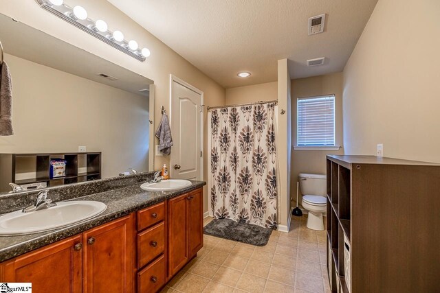 bathroom with visible vents, a sink, tile patterned flooring, and toilet