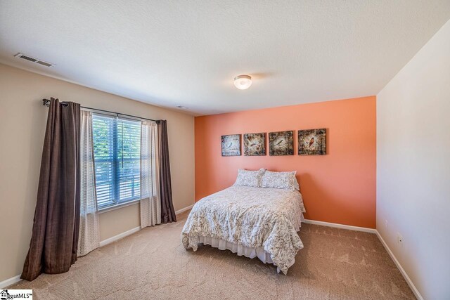 bedroom featuring carpet floors, baseboards, and visible vents