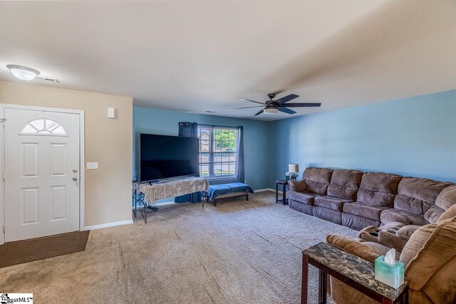 living room featuring baseboards, ceiling fan, and carpet flooring