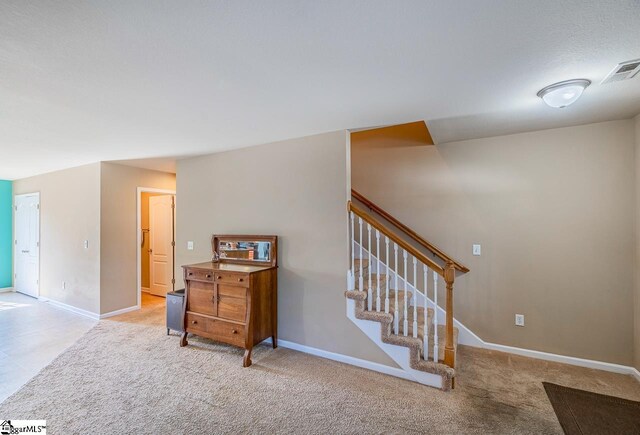 stairs with baseboards, carpet floors, and visible vents