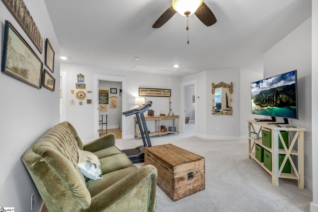 living area with baseboards, attic access, recessed lighting, light colored carpet, and a ceiling fan