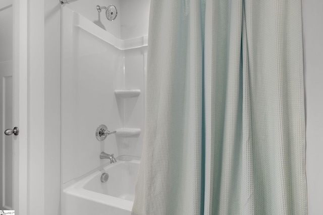 bathroom featuring shower / tub combo with curtain