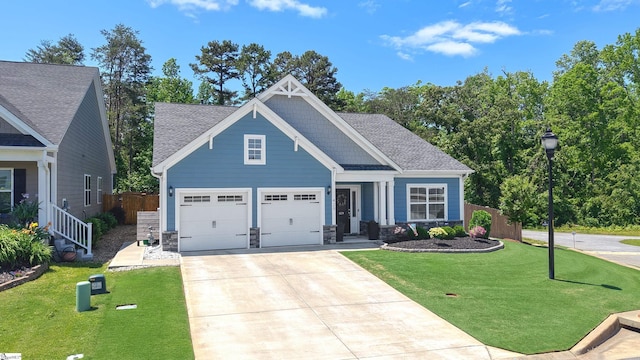429 Rubia Dr, Greenville, SC 29607 - craftsman house featuring fence, an attached garage, a shingled roof, a front lawn, and concrete driveway