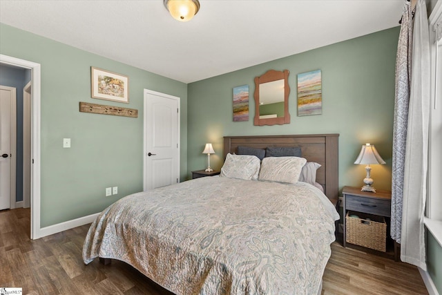 bedroom with baseboards and wood finished floors