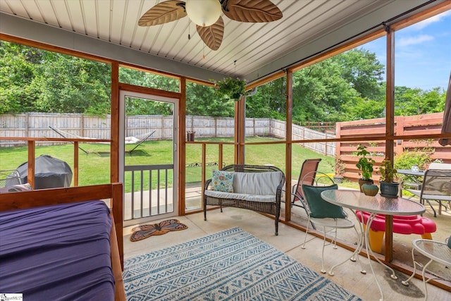 sunroom featuring plenty of natural light and ceiling fan