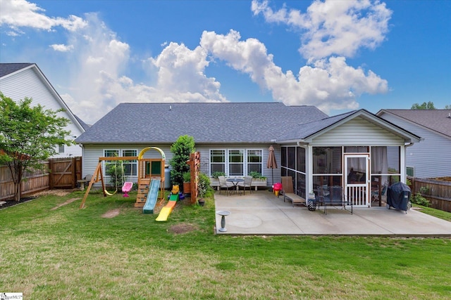 back of property with a fenced backyard, a sunroom, a patio area, a playground, and a yard