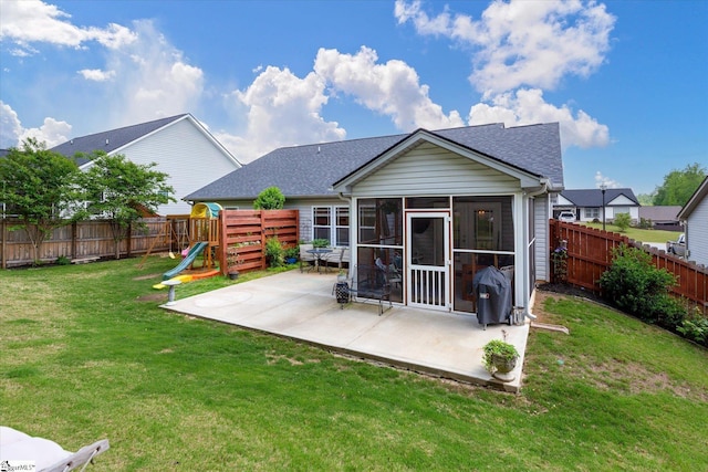 rear view of house with a yard, a patio, a fenced backyard, and roof with shingles
