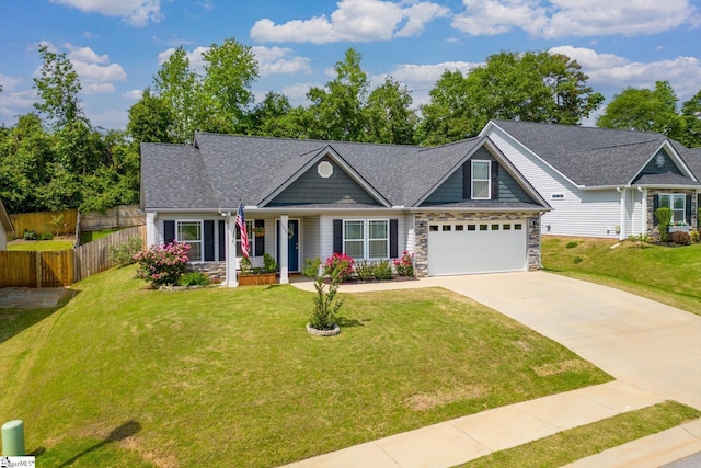 craftsman-style home with concrete driveway, fence, covered porch, and a front lawn