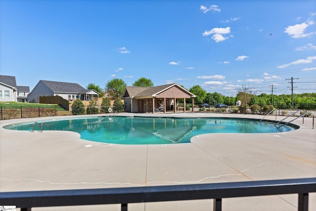 pool featuring a patio and fence