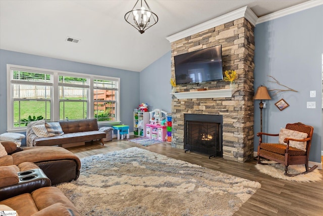 living room with a stone fireplace, wood finished floors, lofted ceiling, visible vents, and ornamental molding