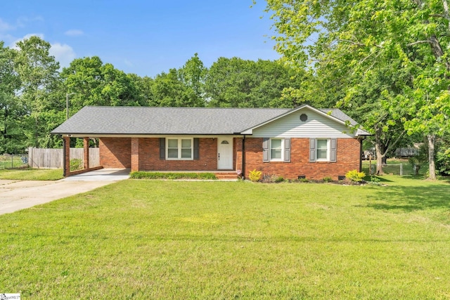 ranch-style house featuring a front yard, brick siding, fence, concrete driveway, and an attached carport