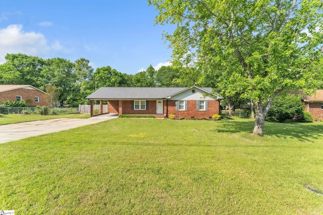 single story home featuring fence, brick siding, an attached carport, a front yard, and driveway