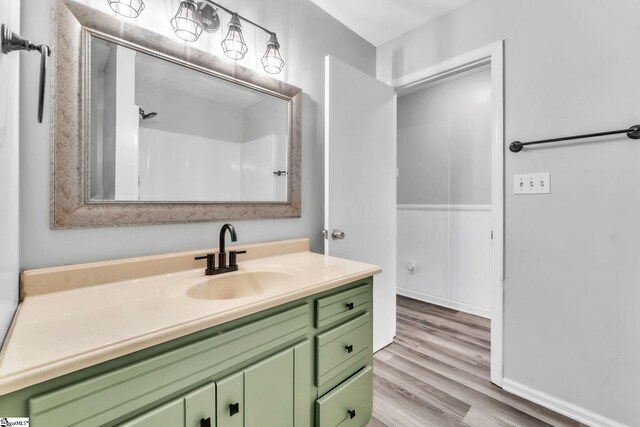 bathroom with vanity and wood finished floors
