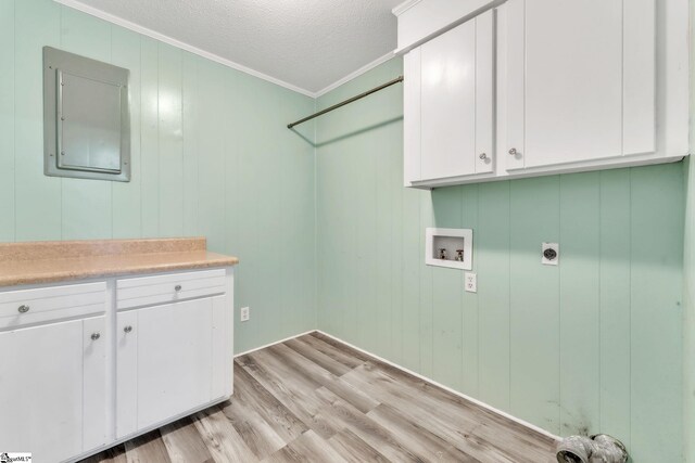 laundry area featuring washer hookup, electric panel, electric dryer hookup, cabinet space, and ornamental molding