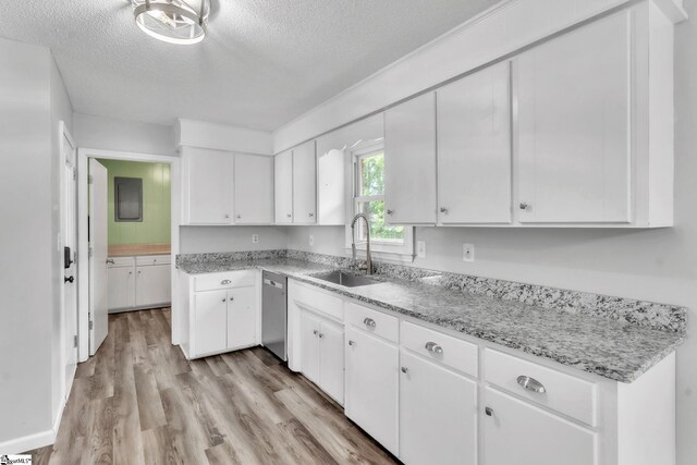 kitchen with a sink, dishwasher, light wood-style floors, a textured ceiling, and white cabinetry