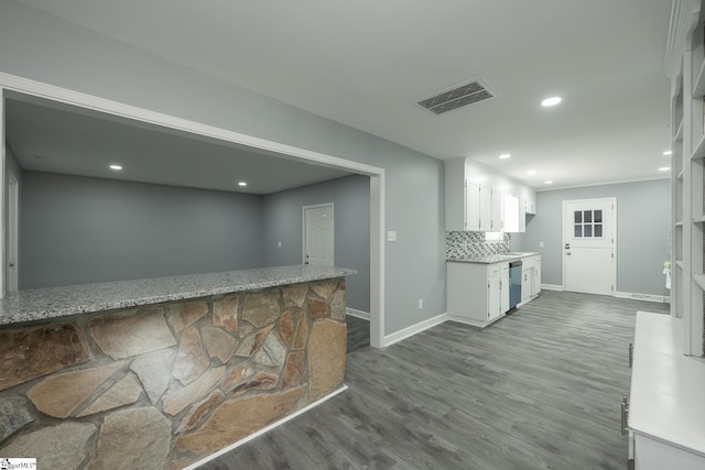 kitchen with a sink, dishwasher, recessed lighting, visible vents, and dark wood-style floors