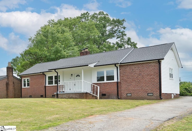single story home with a chimney, brick siding, a front yard, and crawl space