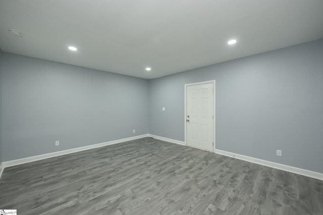 unfurnished room with recessed lighting, baseboards, and dark wood finished floors