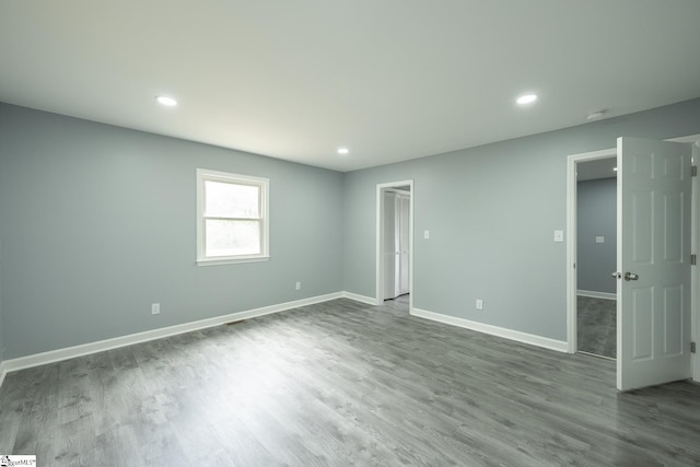 unfurnished bedroom featuring recessed lighting, baseboards, and wood finished floors