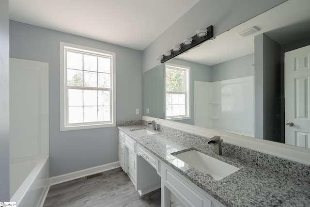 full bathroom with walk in shower, visible vents, and a sink