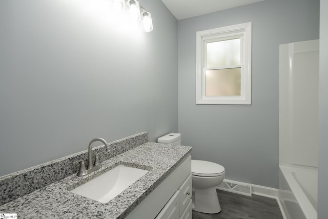 full bathroom featuring vanity, toilet, baseboards, wood finished floors, and visible vents