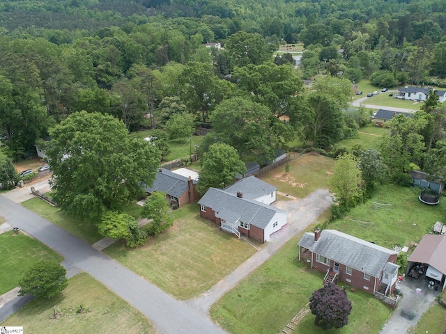 birds eye view of property featuring a view of trees