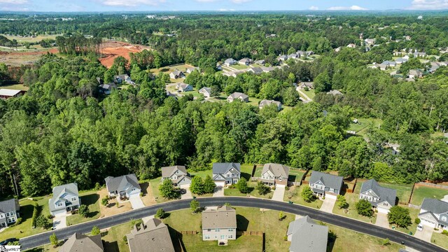 birds eye view of property featuring a view of trees and a residential view