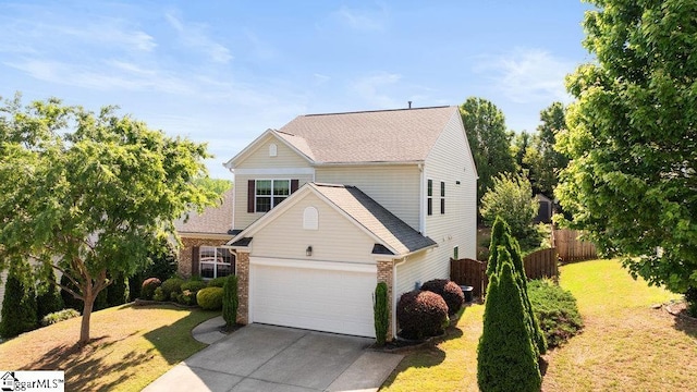 view of front facade featuring fence, driveway, brick siding, and a garage