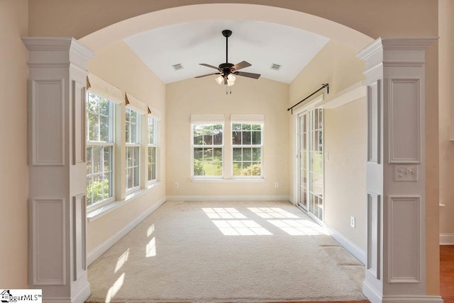 unfurnished sunroom with arched walkways, visible vents, and a wealth of natural light